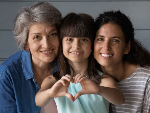 family of women close up making heart hands family of women close up making heart hands