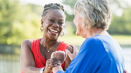 happy multi ethnic woman holding hands happy multi ethnic woman holding hands