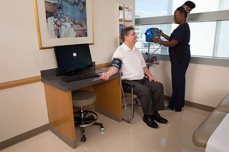nurse checking a patient's blood pressure nurse checking a patient's blood pressure